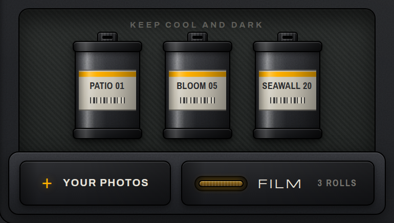 The open film drawer on the bench: three sealed starter cassettes above the YOUR PHOTOS key and the drawer face